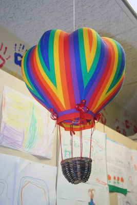colorful miniature hot air balloon hanging from the ceiling