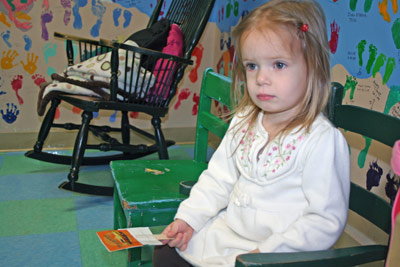 young girl holding sticker-pop in the waiting room