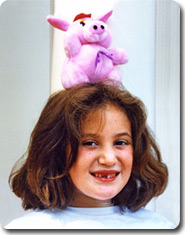 Julie balancing a stuffed bunny on top of her head