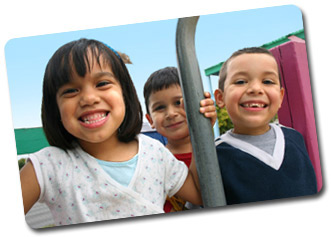 three smiling friends on a playground